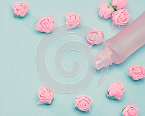 Perfume spray bottle and small pink roses