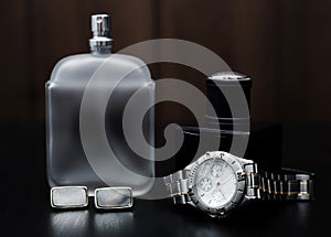 Perfume and watches on a wooden background. Men`s Accessori photo