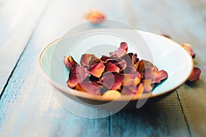 Perfumed dried rose petals placed in a large bowl.