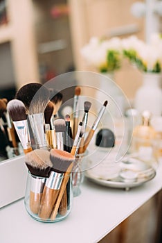 Perfumery and cosmetics on a dressing table with a mirror