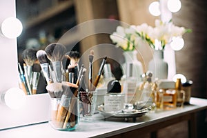 Perfumery and cosmetics on a dressing table with a mirror