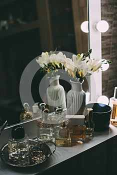 Perfumery and cosmetics on a dressing table with a mirror
