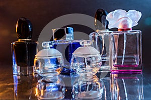 Perfumes in bottles on dark background close up