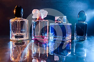 Perfumes in bottles on dark background close up