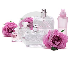 Perfumes with roses on white background