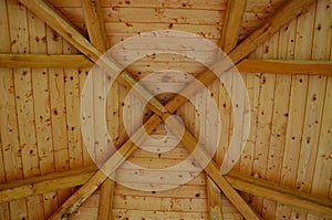 Pergola ceiling made of wooden beams by carpentry by grafting wood into the shape of an octagon. at the top are windows like a lig