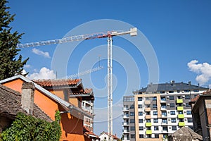 Peri urban scenery of the suburb of Belgrade, with cranes on a construction site with modern housing buildings being built