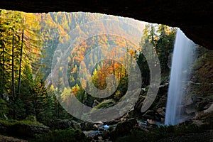 Pericnik Falls, waterfall with orange tree in Triglav National Park, Slovenia. Landscape in nature Europe. Foggy Triglav Alps