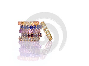 Peridot, Garnet, Yellow, Blue, purple and green sapphire Jewel or gems ring on white background with reflection. Collection of