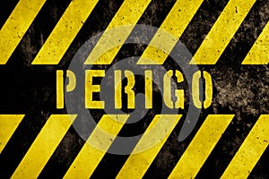 Perigo in Portuguese language, danger warning sign text with yellow and dark stripes painted over concrete wall facade texture photo