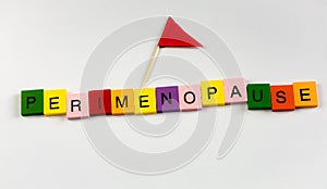 Perimenopause text in letter blocks with flag photo
