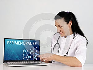 PERIMENOPAUSE text in list. Podiatrist looking for something at laptop