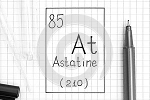The Periodic table of elements. Handwriting chemical element Astatine At with black pen, test tube and pipette