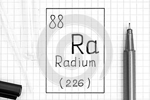 The Periodic table of elements. Handwriting chemical element Radium Ra with black pen, test tube and pipette