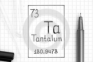 The Periodic table of elements. Handwriting chemical element Tantalum Ta with black pen, test tube and pipette
