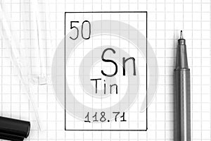 The Periodic table of elements. Handwriting chemical element Tin Sn with black pen, test tube and pipette