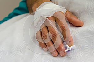 Peripheral venous catheter in man hand