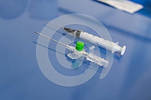 Peripheral venous catheter with syringe placed on the therapy trolley in the infirmary