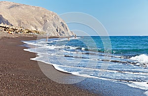Perissa beach with black volcanic sand on the east coast of the Greek island of Santorini