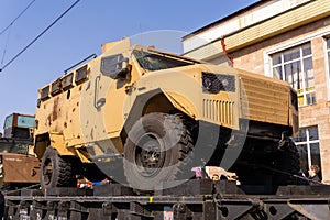 Armored car with holes in armor on the railway flatcar