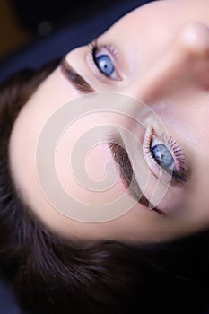 Permanent eyebrow makeup close-up. model girl with blue eyes