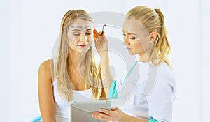 Permanent Makeup For Eyebrows. Beautiful Woman With Thick Brows In Beauty Salon. Beautician Doing Eyebrow Tattooing For