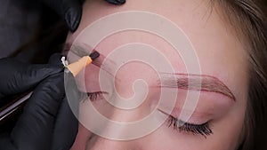 Permanent makeup procedure, performing PMU of eyebrows