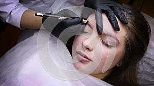 Permanent makeup procedure, performing PMU of eyebrows