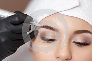 Permanent makeup. Tattooing of eyebrows