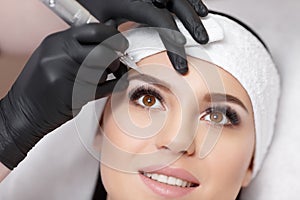 Permanent makeup. Tattooing of eyebrows