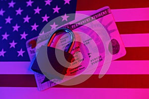 Permanent resident green card for US DV-lottery with small padlock on US flag