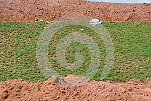 Permanent slope protection using the close turfing method to prevent erosion.