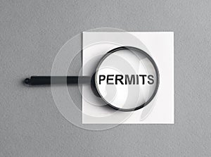 Permits word through magnifying glass. Permission and approval concept