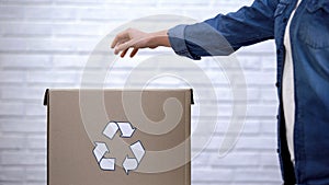 Peron throwing litter into trash bin, waste sorting concept, recycling system