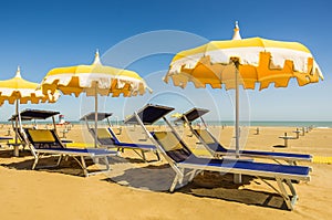 Umbrellas and sunbeds - Rimini Beach, Italy photo