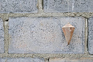 Perpendicularly on brick block.