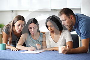 Perplexed roommates checking contract at home photo
