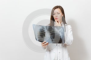 Perplexed focused doctor woman with X-ray of lungs, fluorography, roentgen isolated on white background. Female doctor