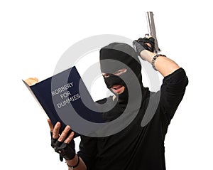 Perplexed robber with gun reads book over white.