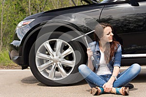 Perplexed woman waiting for roadside assistance