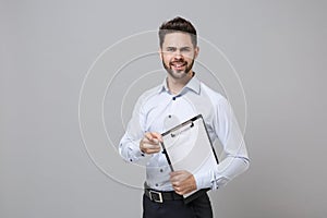 Perplexed young business man in light shirt isolated on grey background. Achievement career wealth business concept