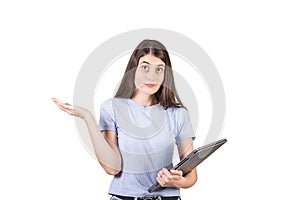 Perplexed young woman shrugging shoulders as holds a defect laptop in her hand, looking confused to camera isolated on white