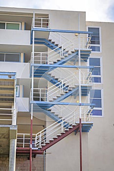 Perron staircase on a building with light blue and red beams at San Clemente, California