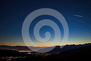 perseid meteor shower over a silhouetted mountain range