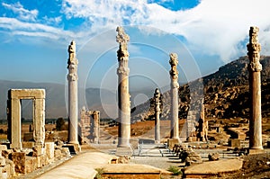 Persepolis is the capital of the ancient Achaemenid kingdom. Ancient columns. Sight of Iran. Ancient Persia. Blue sky and clouds