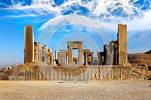 Persepolis is the capital of the ancient Achaemenid kingdom. Sight of Iran. Ancient Persia. Blue sky and clouds background.