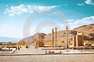 Persepolis, Iran - 8th june, 2022: group of tourist walk by giant column statues. Historical persian city Persepolis in Persia