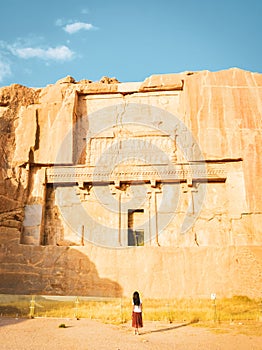 Persepolis, Iran - 8th june, 2022: tourist walk by scenic carved rocks in Persepolis archeological site. Persian city remains and