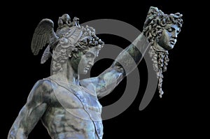 Perseus holding the head of Medusa on black background,Florence