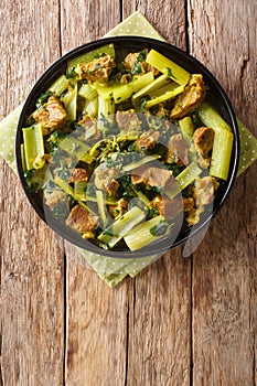 Persian beef and celery stew khoresht karafs closeup in the plate. Vertical top view